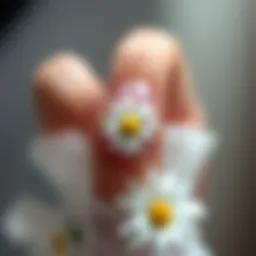 Elegant white daisy nail sticker design on a manicured nail